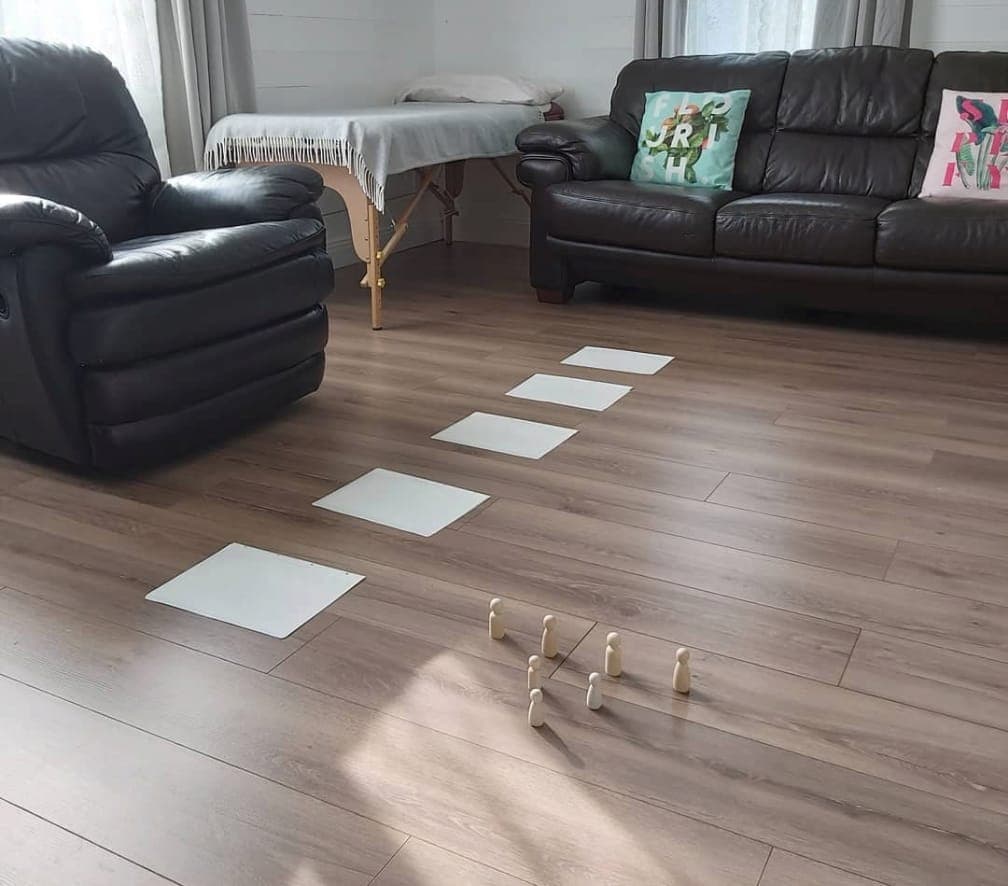 Whitebeam's Theory of Life Coaching setup in Carlow: wooden figurines and paper cards laid out on the floor of the coaching room